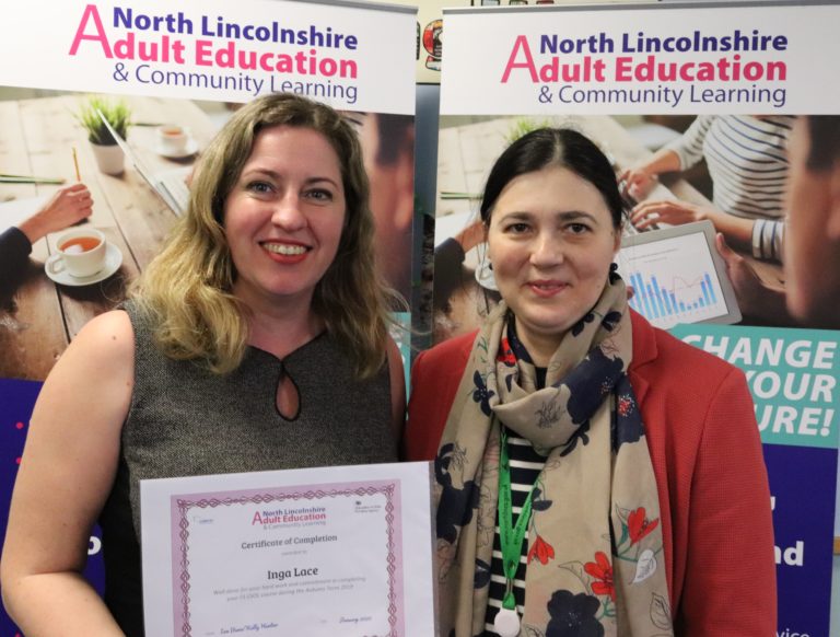 Esol Learner receives certificate from tutor