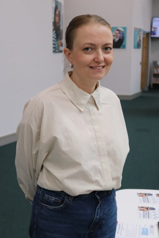 Learner dressed in a cream shirt smiling