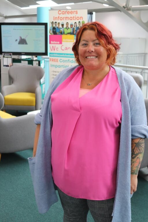 Learner dressed in a pink shirt smiling